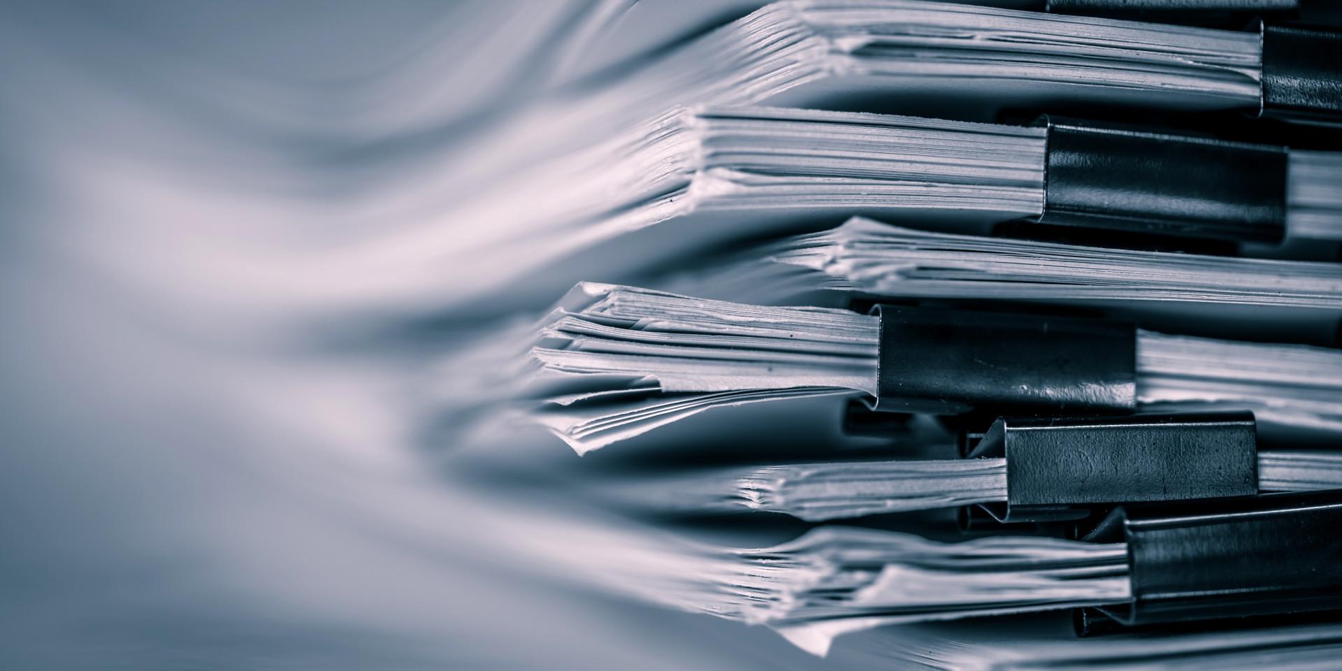 extreamely close up  report paper stacking of office working document , retro color tone